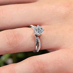 Woman with a simple diamond engagement ring on her hand